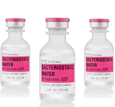 A person in a red crop top pulls loose blue jeans' waistband outward, showing weight loss from Custom Item’s Injection Kit for Weight Loss Regimens (6 Month Supply). Price increased $30.28 from $24.53 for all Exel items on 5/1/25.