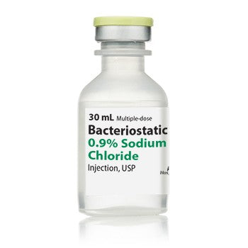 A clear vial labeled "Bacteriostatic 0.9% Sodium Chloride Injection, USP (30 mL bottle)," by Henry Schein, with a green and gray cap, used as sodium chloride for injection.